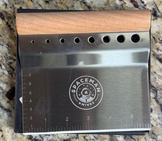 Spaceman Space Scraper stainless steel kitchen tool with wooden handle for chopping and herb stripping.