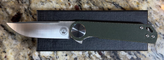 Spaceman Neso EDC Knife with Micarta handle and D2 steel blade on granite surface.