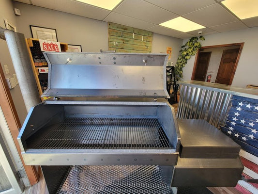 Smokerbuilder Legend 2400 Offset Stick Burner with open lid showcasing cooking surface, perfect for outdoor grilling.