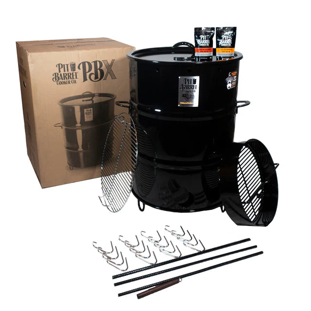 Pit Barrel 22.5" PBX Drum Smoker W/ Stand with cooking accessories for grilling and barbecue.