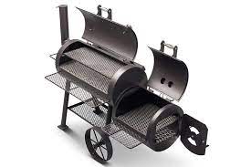 Yoder loaded Wichita offset smoker showcasing charcoal grates, heat plate, and dual thermometers for premium grilling.