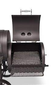 Yoder loaded Wichita offset smoker with opened cooking chamber and removable cooking grates.