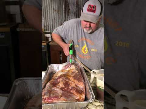 Best Damn Injector ( BDI ) being used to inject flavor into meat for grilling with BBQ tools and accessories.