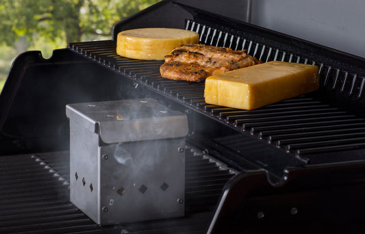 4x4 Smoker Box on grill with cheese and chicken, perfect for grills smokers and cookers, adding rich smoke flavor.