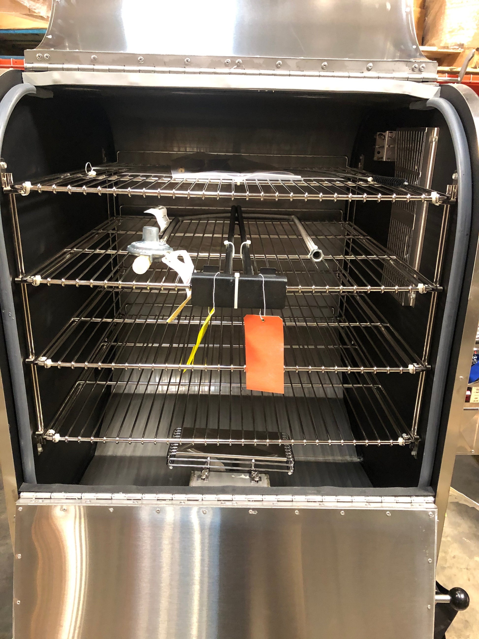 Interior view of the Ole Hickory Ace MM Smoker showcasing sliding racks and features for competition BBQ.