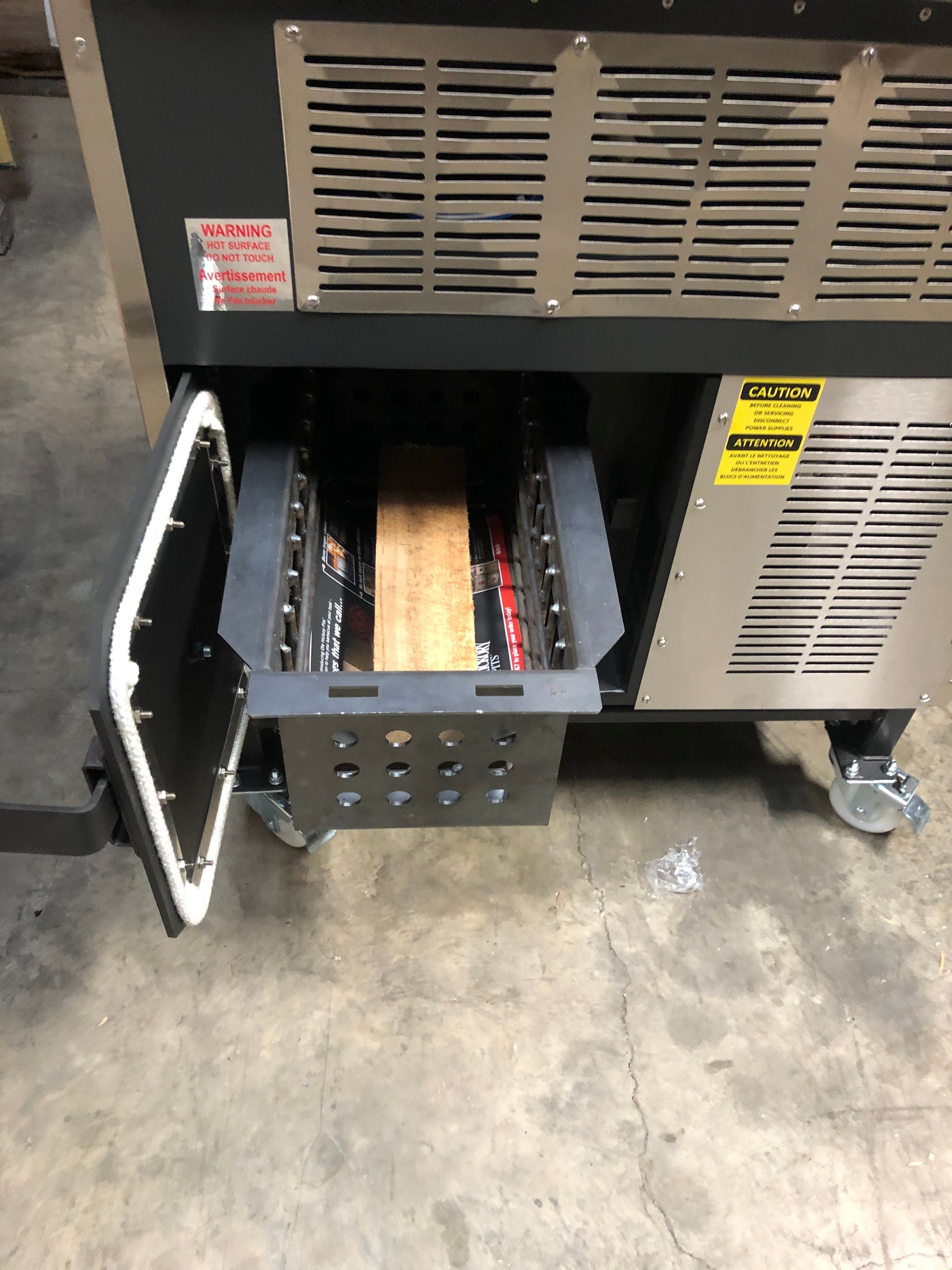 Close-up of the Ole Hickory Ace MM Smoker's firebox and ash catcher showcasing its heavy-duty construction.