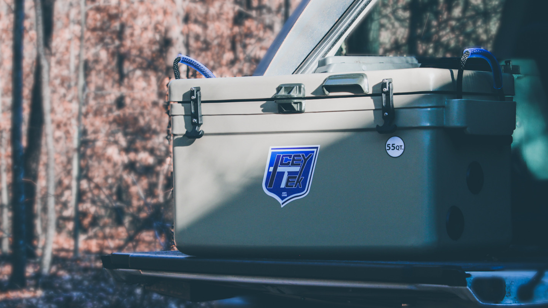 ICEY-TEK 55 Quart Cooler (FREE SHIPPING) on outdoor surface for camping and BBQ adventures.