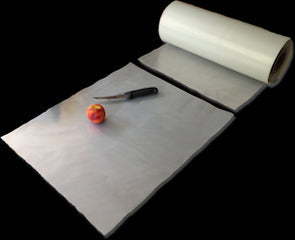 by Stark Stark Boards Disposable Cutting Boards 25/Roll with knife and fruit on a countertop.