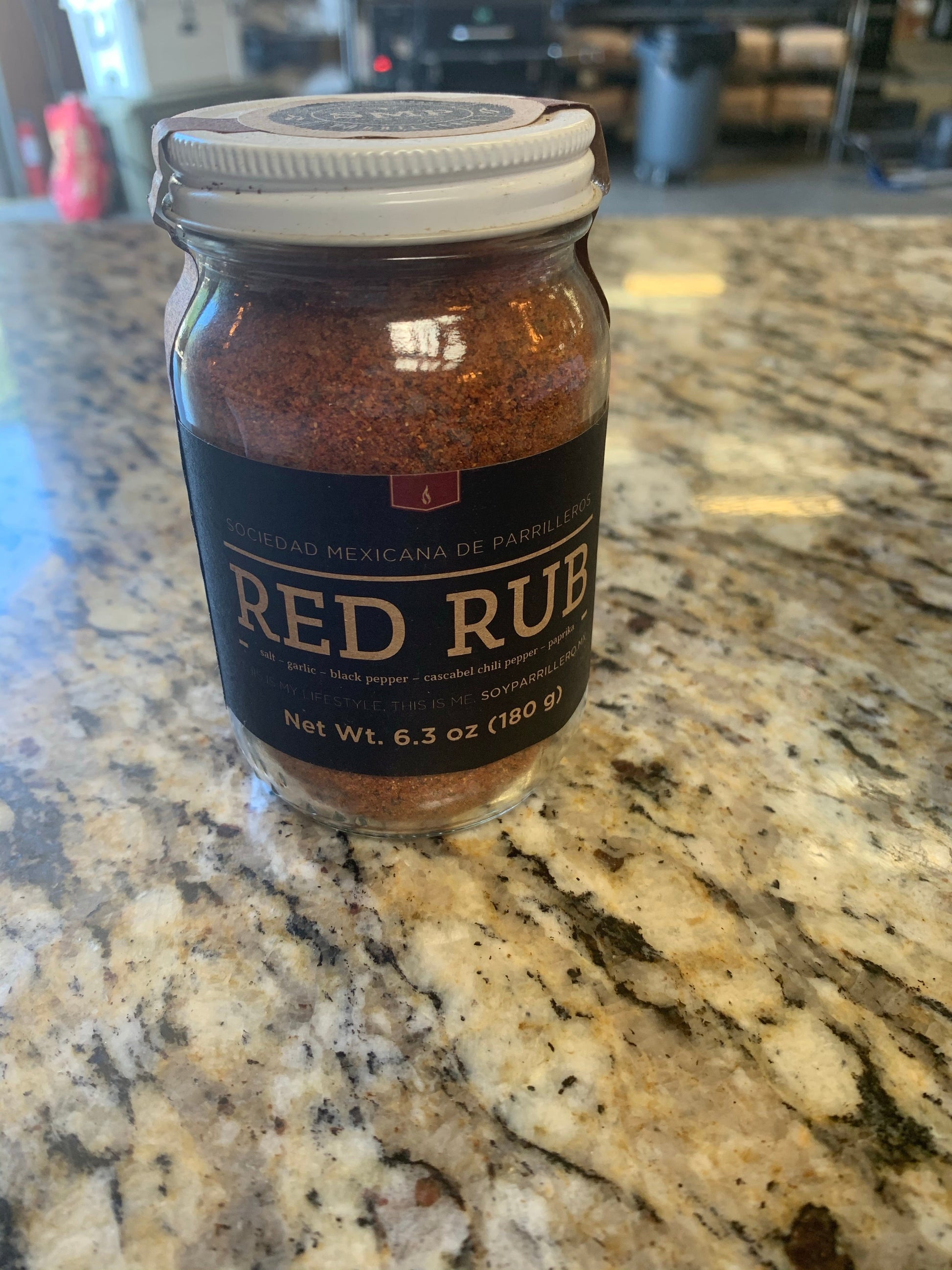 SMP rub in a glass jar on a granite countertop, perfect for grills smokers and cookers.