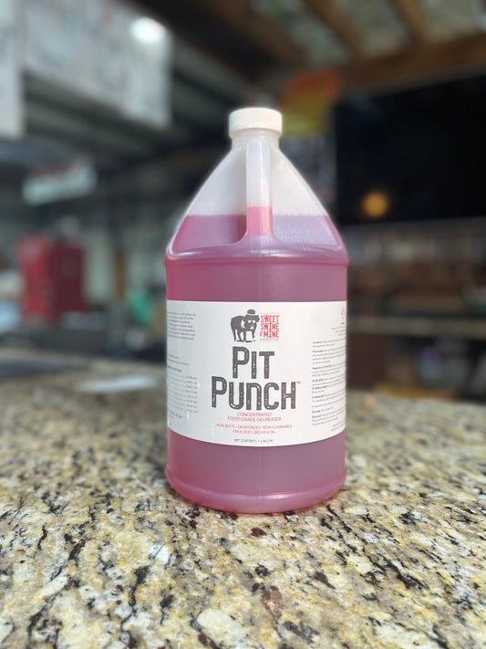 Pit Punch Pit Cleaner Gallon in a clear plastic container on a granite countertop, ideal for cleaning grills smokers and cookers.