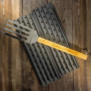 GrillGrate 12" Set for Red Box Smoker with grilling tool on wooden surface, perfect for outdoor cooking and grilling.
