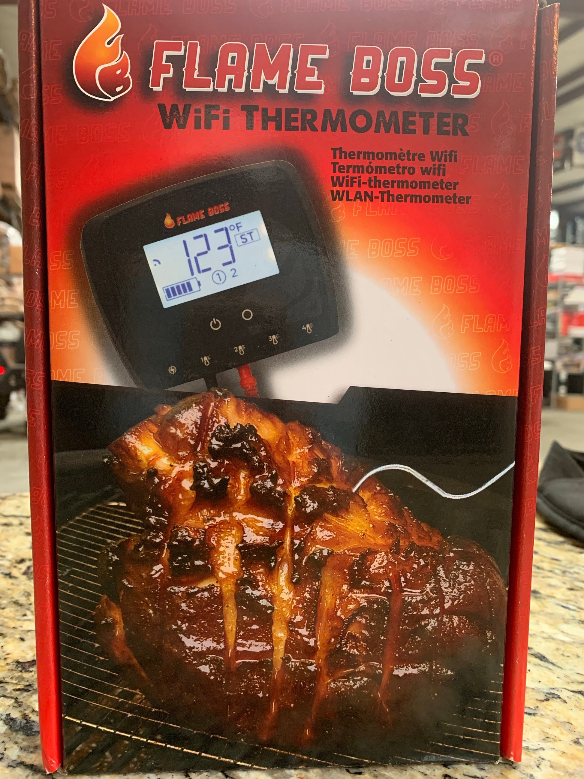 Flame Boss WiFi thermometer displayed with delicious barbecue meat on a grill, ideal for grills smokers and cookers.