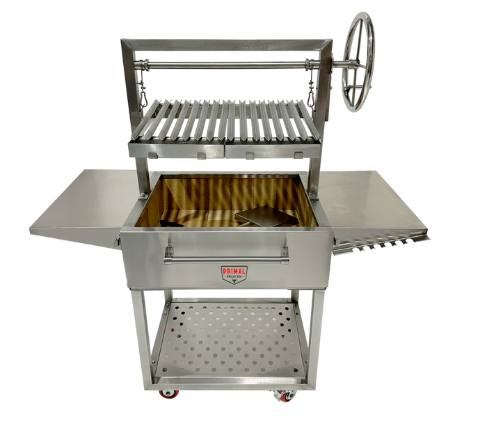 Primal Grills Live Fire Model 32 Inch fully stainless steel grill with side tables and rotisserie feature for outdoor cooking.