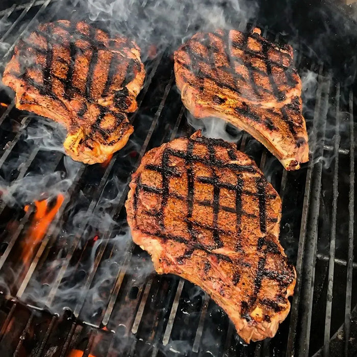 GrillGrates for the All New PK Classic 300 grilling delicious steaks with perfect grill marks on a charcoal grill.