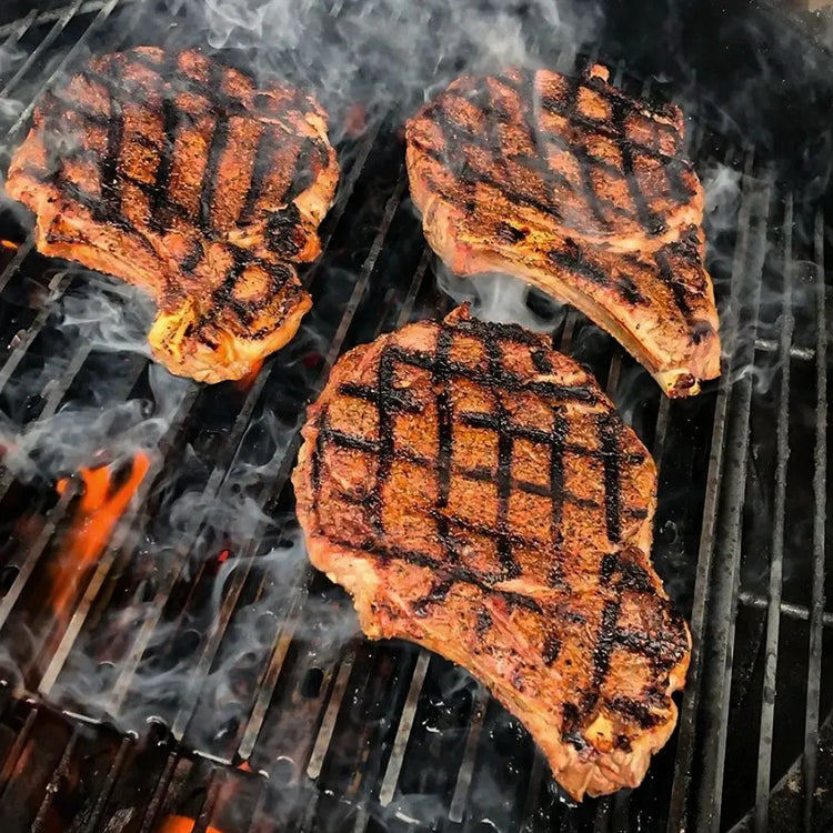 GrillGrates for the All New PK Classic 300 grilling delicious steaks with perfect grill marks on a charcoal grill.