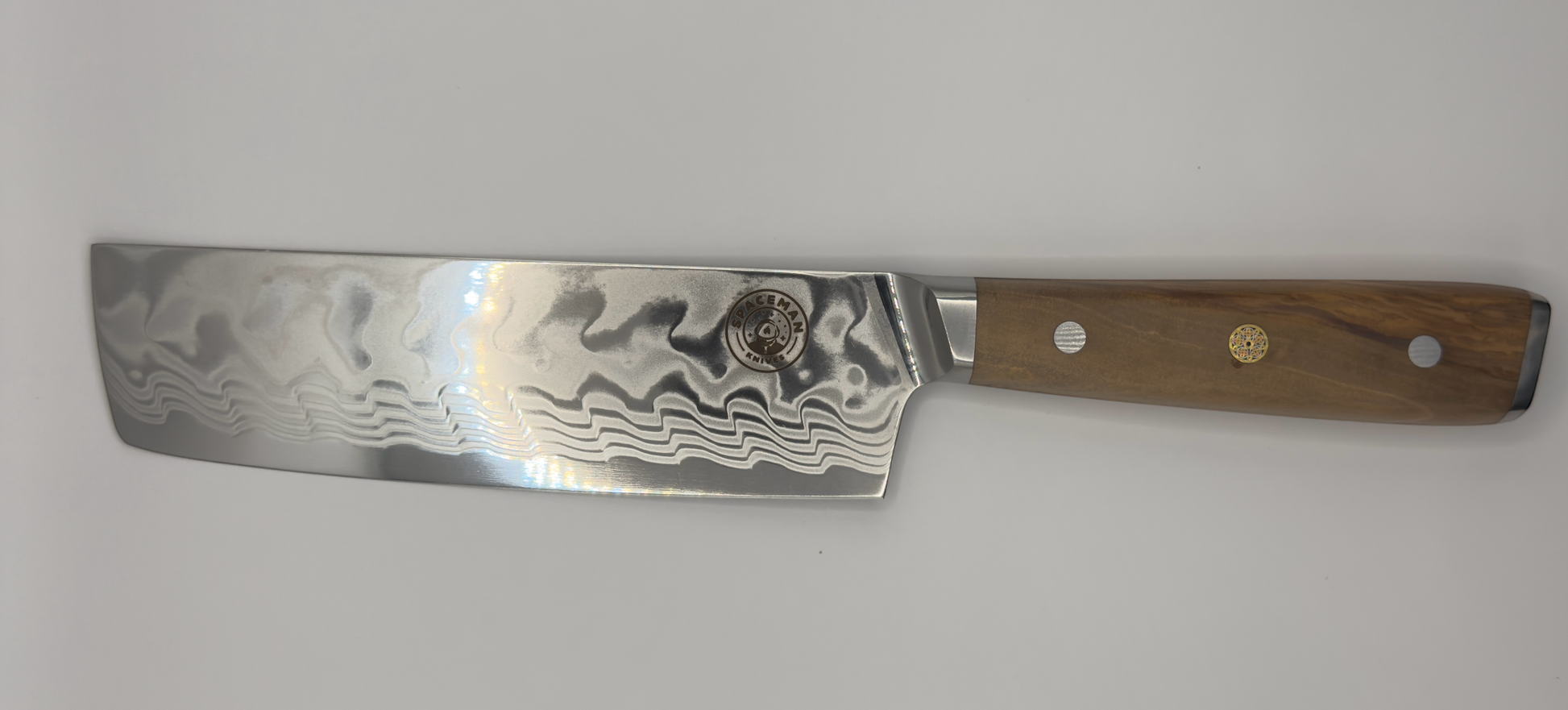 Spaceman Interstellar Olive Nakiri knife with Damascus finish and olive wood handle.