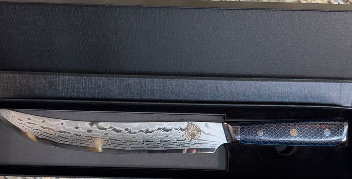 Spaceman Interstellar Blue Scimitar Knife in a sleek presentation box, showcasing its Damascus steel blade.