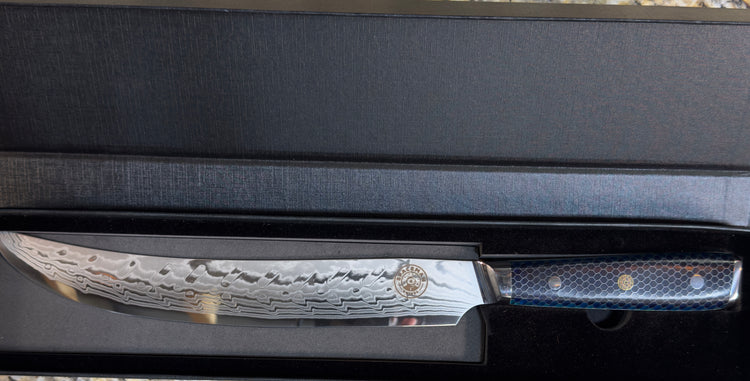 Spaceman Interstellar Blue Scimitar Knife in a sleek presentation box, showcasing its Damascus steel blade.