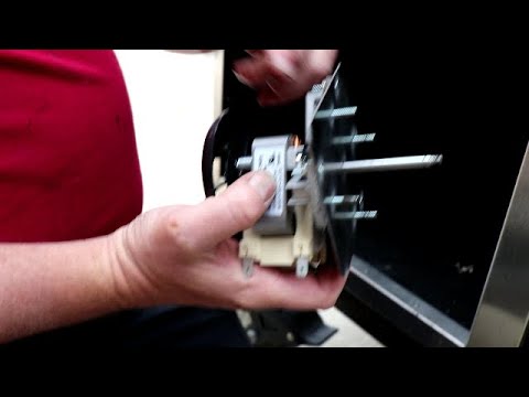 Ole Hickory CTO-DW with competition switch polished stainless steel finish being serviced for optimal grilling performance.