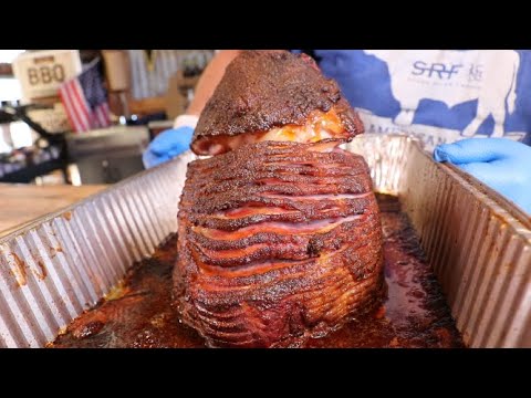 Perfectly smoked ham coated with Sweet Rub O' Mine Apple Chipotle BBQ Rub, ready for serving on outdoor grills.