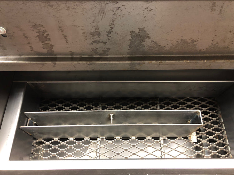 Inside view of the American Barbecue Systems All Star Smoker showcasing the stainless steel smoking racks.