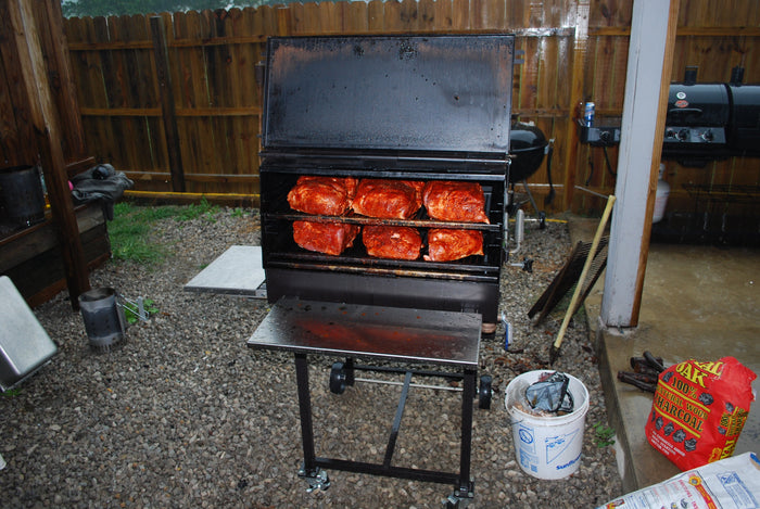 American Barbecue Systems All Star Smoker with meat skewers cooking in backyard setup.